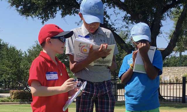 Youth golfers from The First Tee of Greater Dallas using their lesson books