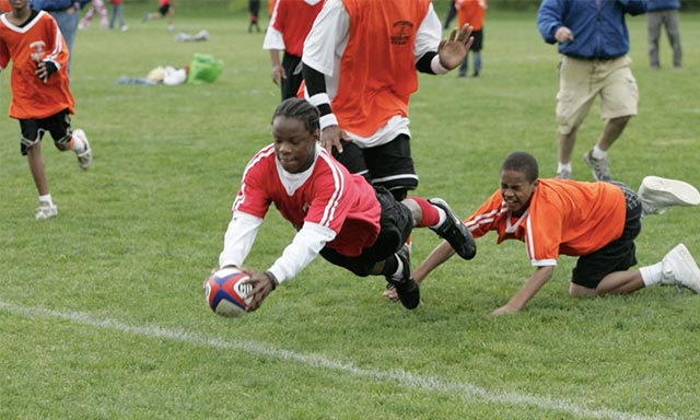 Youth ruby player for Pittsburgh Harlequins diving to score a try