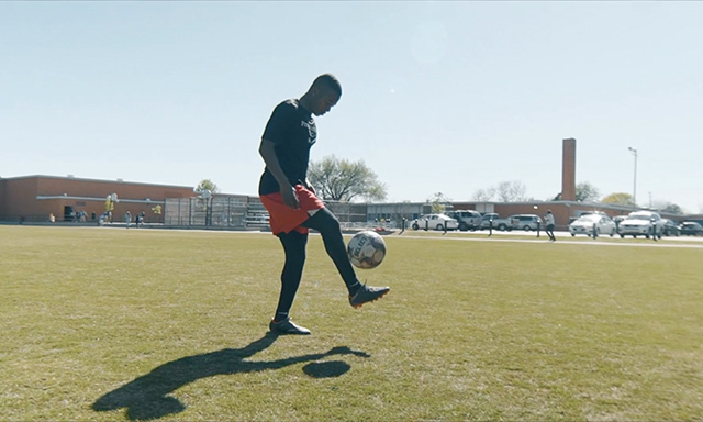 OKC Energy FC soccer player Josh Garcia juggling a soccer ball on an Oklahoma City Public Schools soccer pitch built by Fields & Futures