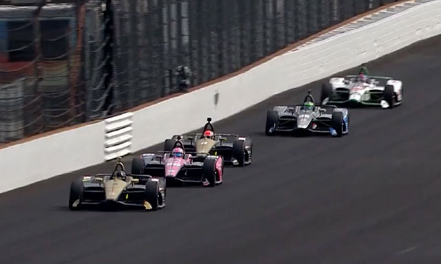 Cars are shown racing on the Indy Motor Speedway in Indianapolis.