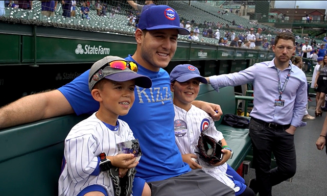Noah Ballard is seen sitting beside Anthony Rizzo during the Community Spotlight - Dream On 3 segment of Season 3, Show 4 of the Power of Sports.